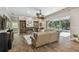 Spacious living room with a fireplace, built-in shelving, and access to the lanai and pool area at 1877 Muirfield Way, Oldsmar, FL 34677