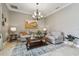 Inviting living room featuring a decorative chandelier and neutral color palette at 1877 Muirfield Way, Oldsmar, FL 34677