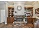 Living room has built-in bookcases and bar, as well as a beautiful stone fireplace at 1877 Muirfield Way, Oldsmar, FL 34677