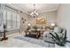 Bright living room with shuttered windows, a chandelier, and neutral color palette at 1877 Muirfield Way, Oldsmar, FL 34677