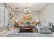 Traditional living room with a chandelier, neutral colors, and lots of natural light at 1877 Muirfield Way, Oldsmar, FL 34677
