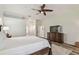 Bright main bedroom with wood-look floors, ceiling fan, and elegant dresser at 1877 Muirfield Way, Oldsmar, FL 34677
