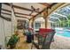 A charming outdoor living space with comfortable seating, a fire pit, and a pool view for relaxation and entertainment at 1877 Muirfield Way, Oldsmar, FL 34677