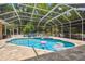 Large screened-in pool with a hot tub and plenty of deck space for outdoor activities at 1877 Muirfield Way, Oldsmar, FL 34677
