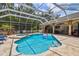 Sparkling pool within a screened enclosure, offering both sun and shade, with a spa at 1877 Muirfield Way, Oldsmar, FL 34677