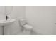 Bathroom featuring a pedestal sink and toilet at 2039 Amelia Bay Pl, Valrico, FL 33596