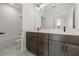 Modern bathroom features a double vanity, tiled shower, and contemporary fixtures at 2039 Amelia Bay Pl, Valrico, FL 33596