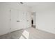 A carpeted bedroom with a large closet and a bathroom at 2039 Amelia Bay Pl, Valrico, FL 33596