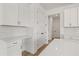 Kitchen area featuring white cabinetry, quartz countertop, and tile backsplash at 2039 Amelia Bay Pl, Valrico, FL 33596