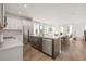 Open-concept living area featuring a kitchen with an island, dining area, and bright living space at 2039 Amelia Bay Pl, Valrico, FL 33596