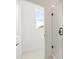 Modern shower with white tiled walls and black hardware, adjacent to the walk-in closet at 2039 Amelia Bay Pl, Valrico, FL 33596