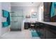Beautiful bathroom with glass shower, dark wood cabinets, dual sinks and tile floors at 2121 Worthington Greens Dr, Sun City Center, FL 33573