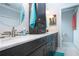 Modern bathroom with dark cabinets, white marble countertops, decorative mirror and a large single sink at 2121 Worthington Greens Dr, Sun City Center, FL 33573