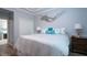 Comfortable bedroom with a large bed, decorative pillows, wood floors, and modern wall art at 2121 Worthington Greens Dr, Sun City Center, FL 33573
