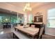 Sunlit dining area with modern furnishings and a view of the enclosed patio at 2121 Worthington Greens Dr, Sun City Center, FL 33573