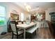 Well-lit dining room with modern lighting, adjacent to the kitchen bar at 2121 Worthington Greens Dr, Sun City Center, FL 33573