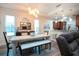 Bright dining area with a modern table, bench seating, and stylish lighting fixture at 2121 Worthington Greens Dr, Sun City Center, FL 33573