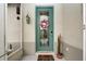 Close-up of a charming front door adorned with a wreath, with a colorful welcome mat at 2121 Worthington Greens Dr, Sun City Center, FL 33573