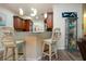 Bright kitchen featuring granite countertops, modern pendant lighting, and wooden cabinetry for a luxurious feel at 2121 Worthington Greens Dr, Sun City Center, FL 33573