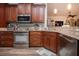Kitchen area with stainless steel appliances, granite countertops, and wood cabinets at 2121 Worthington Greens Dr, Sun City Center, FL 33573