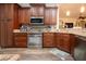 Well-equipped kitchen featuring stainless steel appliances, granite countertops, and wooden cabinets at 2121 Worthington Greens Dr, Sun City Center, FL 33573