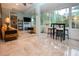 Sunlit living room with tile floors, and cozy seating, and many windows to enjoy the view at 2121 Worthington Greens Dr, Sun City Center, FL 33573