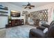 Comfortable living room featuring a ceiling fan, wall decor, and plush seating at 2121 Worthington Greens Dr, Sun City Center, FL 33573