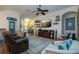Comfortable living room featuring a ceiling fan, large TV, and neutral-toned furniture at 2121 Worthington Greens Dr, Sun City Center, FL 33573