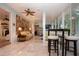 Sunlit living room with tile floors, wood accent wall, and cozy seating, perfect for relaxation and entertaining at 2121 Worthington Greens Dr, Sun City Center, FL 33573