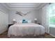 Cozy bedroom features tray ceilings, wood floors, and lots of natural light at 2121 Worthington Greens Dr, Sun City Center, FL 33573