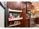 Functional pantry with pull-out shelving for convenient storage in the kitchen at 2121 Worthington Greens Dr, Sun City Center, FL 33573