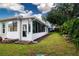 Bright sunroom with multiple windows, a door to the backyard, and access to a lush lawn at 2121 Worthington Greens Dr, Sun City Center, FL 33573