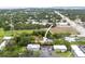 Aerial view of property with green space, proximity to shops and main roads; arrow points to the home at 2174 62Nd N St, Clearwater, FL 33760