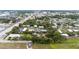 Picturesque aerial view of a community with diverse housing, tree-lined streets, and a charming church steeple at 2174 62Nd N St, Clearwater, FL 33760