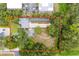 Overhead view of the home reveals surrounding property with a pond, landscaping and parking at 2174 62Nd N St, Clearwater, FL 33760