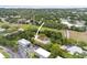Aerial view of property with green space, proximity to shops and main roads; arrow points to the home at 2174 62Nd N St, Clearwater, FL 33760