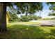 Expansive backyard featuring a well-maintained lawn, mature trees, and a serene atmosphere at 2174 62Nd N St, Clearwater, FL 33760