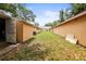A view of the back yard with multiple storage buildings at 2174 62Nd N St, Clearwater, FL 33760