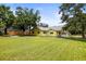Large backyard with lush lawn, trees, and ample space for outdoor activities and entertaining at 2174 62Nd N St, Clearwater, FL 33760