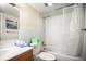 Clean bathroom with shower and tub combo, tile walls, toilet, and a wood vanity at 2174 62Nd N St, Clearwater, FL 33760