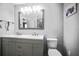 Bright bathroom featuring double sink vanity with gray cabinets and a framed mirror at 2174 62Nd N St, Clearwater, FL 33760