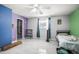 Bright room with tile floors, ceiling fan, and closet, featuring blue and purple walls at 2174 62Nd N St, Clearwater, FL 33760