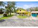 Charming yellow home with a large, inviting porch and a well-manicured front yard at 2174 62Nd N St, Clearwater, FL 33760