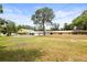 Inviting yellow home with a charming front porch and spacious yard, perfect for outdoor activities at 2174 62Nd N St, Clearwater, FL 33760