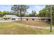 View of the home and garage unit with surrounding green space at 2174 62Nd N St, Clearwater, FL 33760