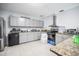 Modern kitchen with gray cabinets, stainless steel appliances, and bar seating at 2174 62Nd N St, Clearwater, FL 33760