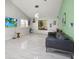 Spacious living room with vaulted ceilings, a large window, and a comfortable leather sofa at 2174 62Nd N St, Clearwater, FL 33760