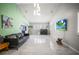 Bright living room featuring tiled floors, a black leather sofa and large windows at 2174 62Nd N St, Clearwater, FL 33760