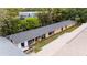 Aerial view of the back of the home and attached garage units with grey roof and peach painted exterior walls at 2174 62Nd N St, Clearwater, FL 33760