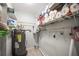 Utility room with shelving, stocked with paper products, and a hot water heater at 2174 62Nd N St, Clearwater, FL 33760